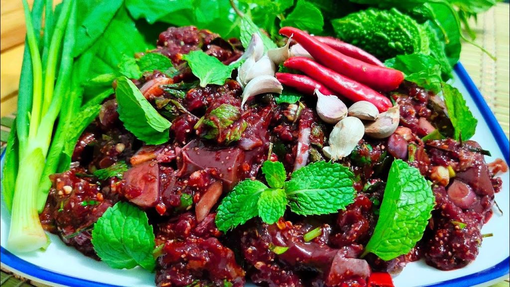 Plate of Larb Leuat Neua raw beef salad with herbs