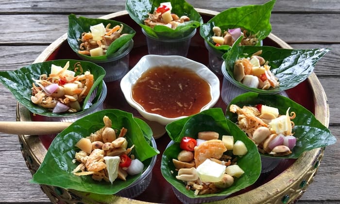 Traditional Miang Kham leaf wraps with toasted coconut, lime, peanuts, and dried shrimp