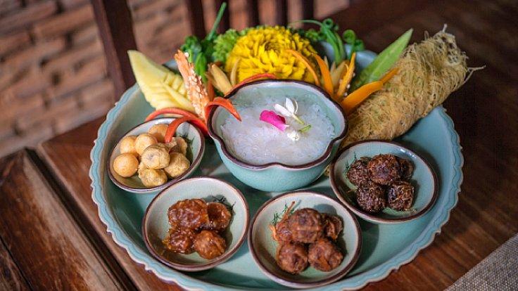 Bowl of Khao Chae with jasmine rice soaked in fragrant jasmine water and side dishes
