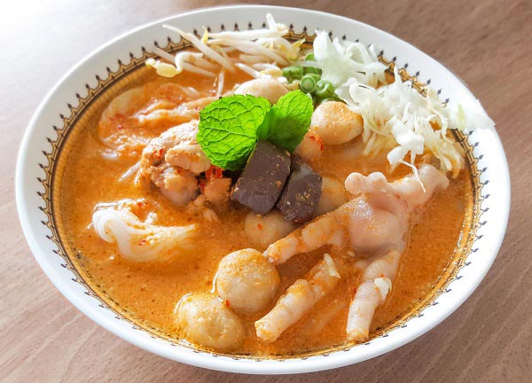 Southern Thai Khanom Jeen Nam Ya spicy curry noodles with boiled eggs and fresh vegetables