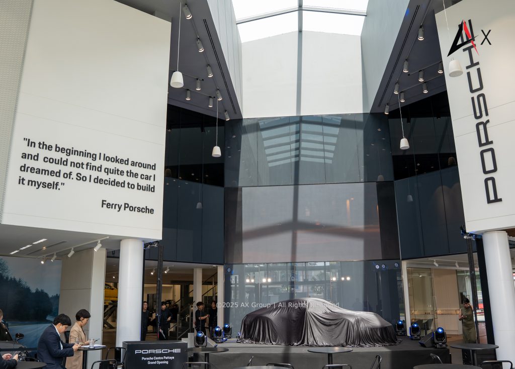 "Luxury showroom at Porsche Centre Pattaya featuring a curated display of Porsche models, digital configurators, and lifestyle merchandise."