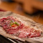 Tableside wagyu beef grilling at Nama Buffet Bangkok rooftop
