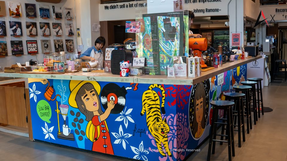 Interior of Recordoffee Bangkok with vinyl racks and minimalist café seating